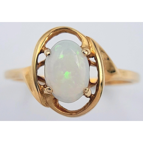 365 - A 9K Yellow Gold Opal Solitaire Ring. Cabochon stone with good colour play. Size J 1/2. 1.4g.