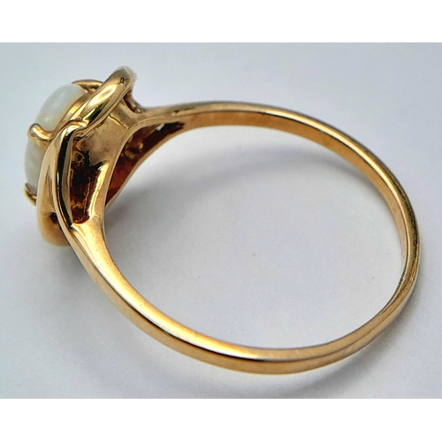 365 - A 9K Yellow Gold Opal Solitaire Ring. Cabochon stone with good colour play. Size J 1/2. 1.4g.