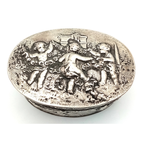 396 - An Antique Silver (800 Purity) German/Dutch Trinket Box. Repoussé decorative work of children playin... 