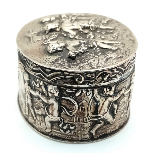 396 - An Antique Silver (800 Purity) German/Dutch Trinket Box. Repoussé decorative work of children playin... 
