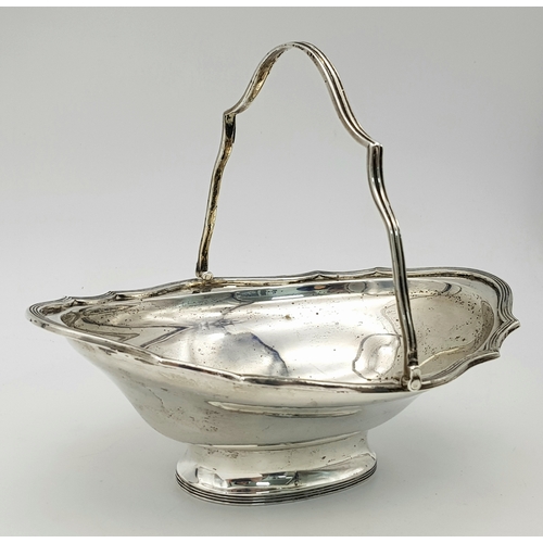 136 - An Antique Sterling Silver Serving Basket with Swing Handle.
Hallmarks for London 1907. 19cm length ... 