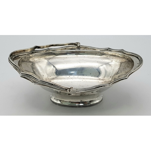 136 - An Antique Sterling Silver Serving Basket with Swing Handle.
Hallmarks for London 1907. 19cm length ... 