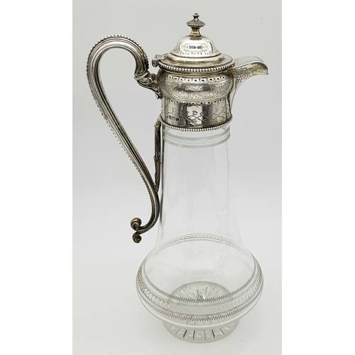 141 - An Antique Victorian Cut Glass Claret Jug with Sterling Silver Scrolled Handle, Lid with ornate fini... 