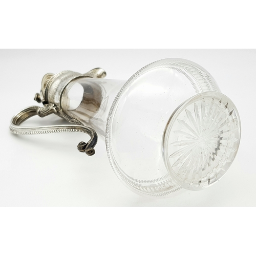 141 - An Antique Victorian Cut Glass Claret Jug with Sterling Silver Scrolled Handle, Lid with ornate fini... 