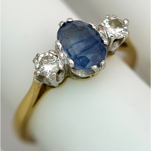 176 - A Gorgeous 18K Yellow Gold Sapphire and Diamond Ring. Oval cut pale blue 0.65ct sapphire with a 0.15... 