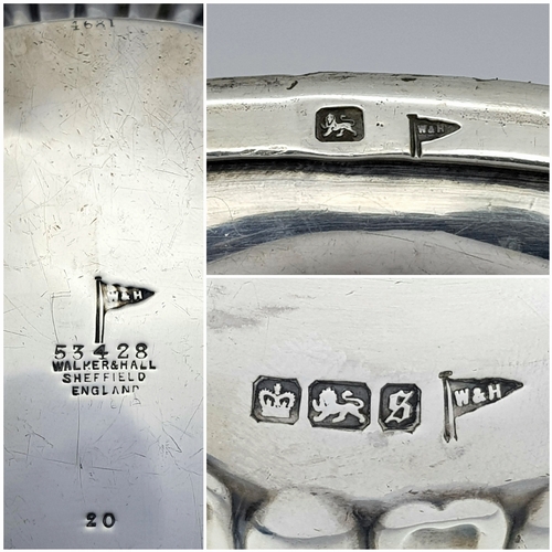 188 - An Antique Sterling Silver Teapot. Part fluted body, bun feet and an angular wooden handle. Hallmark... 