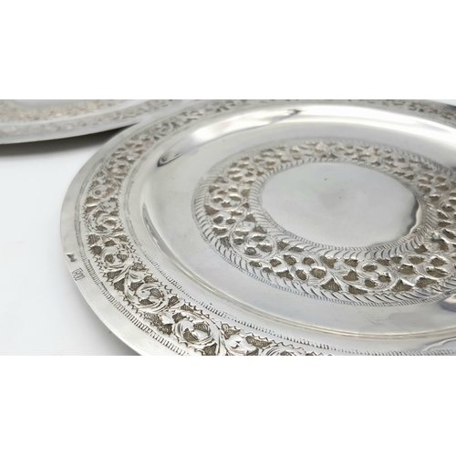 386 - A Pair of 800 Silver Decorative Chased Plates. Intricate foliate patterns along the border and centr... 
