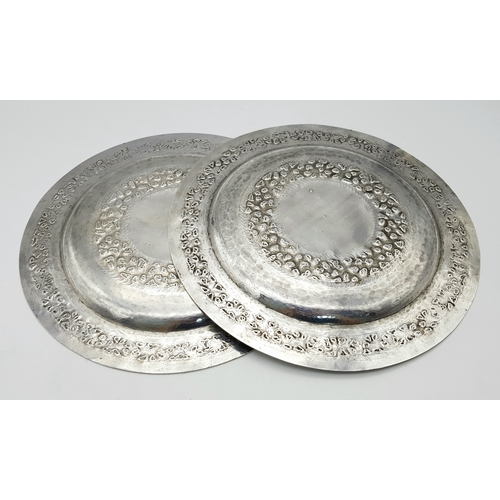 386 - A Pair of 800 Silver Decorative Chased Plates. Intricate foliate patterns along the border and centr... 
