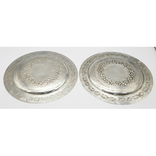 386 - A Pair of 800 Silver Decorative Chased Plates. Intricate foliate patterns along the border and centr... 