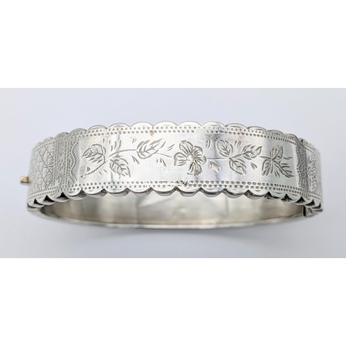 403 - A Vintage Sterling Silver Hinged Bangle Bracelet with a Detailed Engraved Foliage Pattern. Unhallmar... 