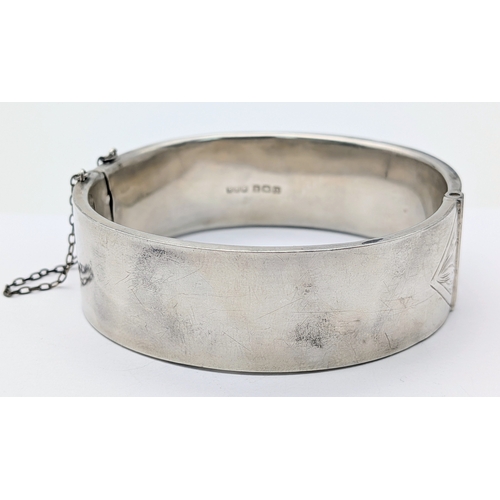 417 - An Antique Engraved Sterling Silver Hinged Bangle Bracelet with Foliate Design and a Safety Chain. H... 