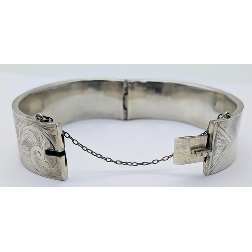 417 - An Antique Engraved Sterling Silver Hinged Bangle Bracelet with Foliate Design and a Safety Chain. H... 