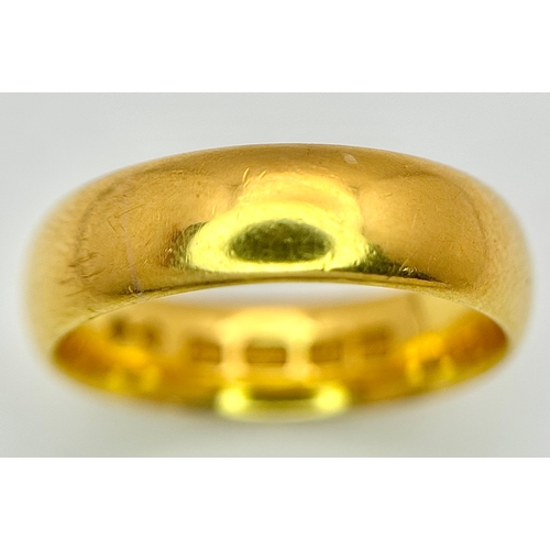 129 - A 22K Yellow Gold Band Ring. 6mm width. Full UK hallmarks. Size M. 6.84g.