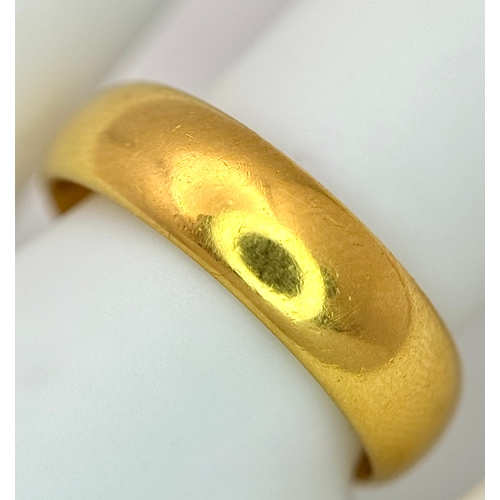 129 - A 22K Yellow Gold Band Ring. 6mm width. Full UK hallmarks. Size M. 6.84g.