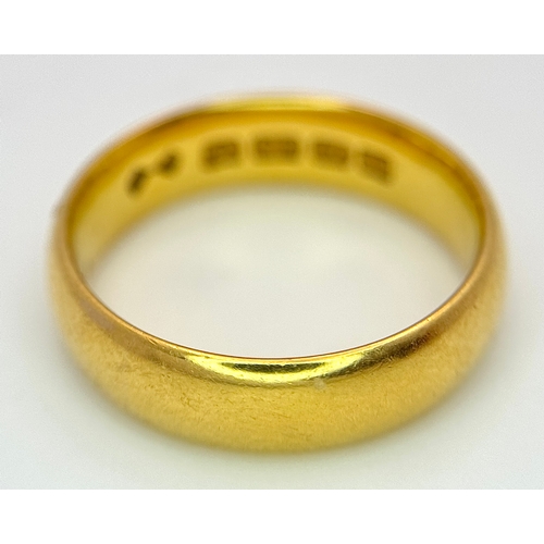 129 - A 22K Yellow Gold Band Ring. 6mm width. Full UK hallmarks. Size M. 6.84g.