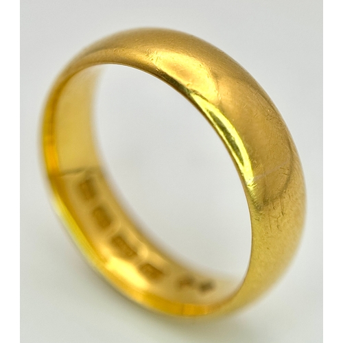 129 - A 22K Yellow Gold Band Ring. 6mm width. Full UK hallmarks. Size M. 6.84g.