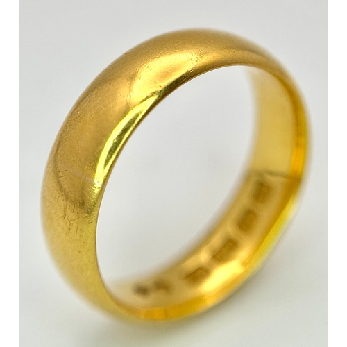 129 - A 22K Yellow Gold Band Ring. 6mm width. Full UK hallmarks. Size M. 6.84g.