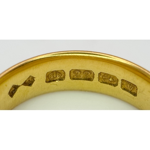129 - A 22K Yellow Gold Band Ring. 6mm width. Full UK hallmarks. Size M. 6.84g.