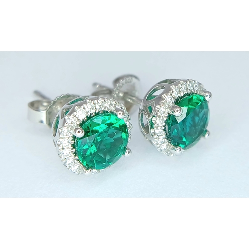 287 - A pair of 14K White Gold, Diamond And Synthetic Emerald Set, Halo Stud Earrings. 2.2G. Tan 6009