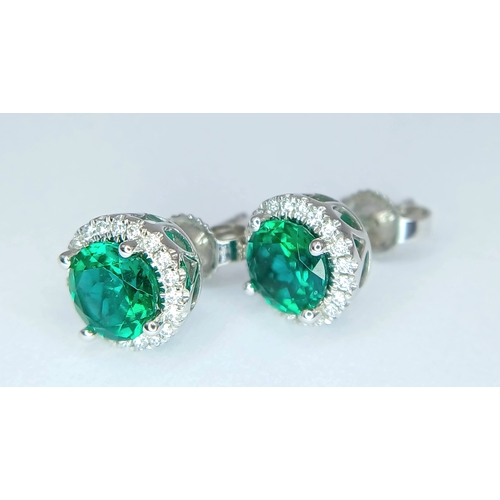 287 - A pair of 14K White Gold, Diamond And Synthetic Emerald Set, Halo Stud Earrings. 2.2G. Tan 6009