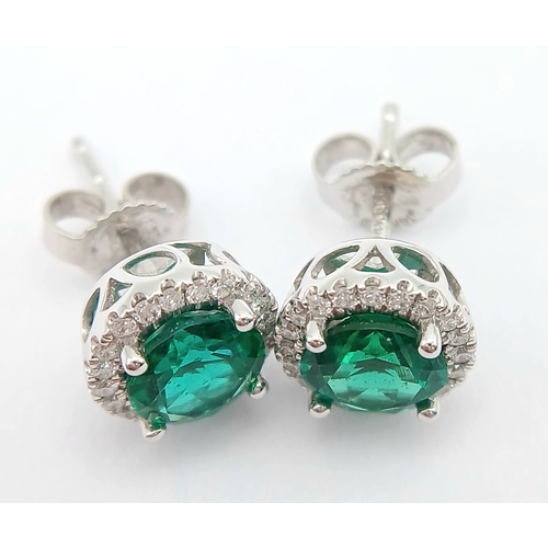 287 - A pair of 14K White Gold, Diamond And Synthetic Emerald Set, Halo Stud Earrings. 2.2G. Tan 6009