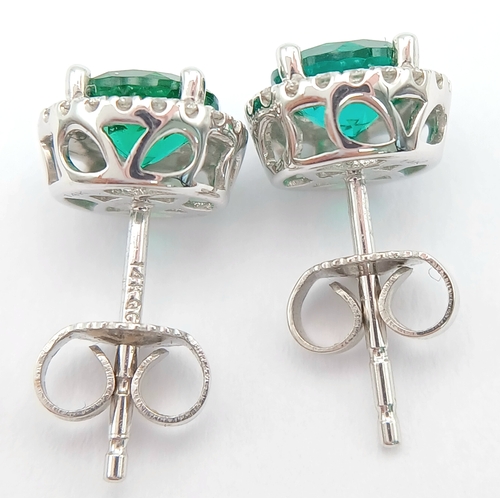 287 - A pair of 14K White Gold, Diamond And Synthetic Emerald Set, Halo Stud Earrings. 2.2G. Tan 6009