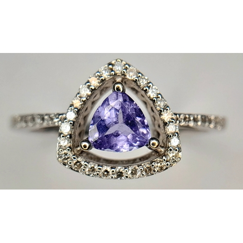 265 - An Attractive 9 Carat White Gold Tanzanite and Diamond Set Ring Size O. The Ring is set with a 5mm T... 