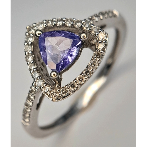 265 - An Attractive 9 Carat White Gold Tanzanite and Diamond Set Ring Size O. The Ring is set with a 5mm T... 