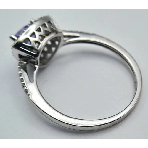 265 - An Attractive 9 Carat White Gold Tanzanite and Diamond Set Ring Size O. The Ring is set with a 5mm T... 