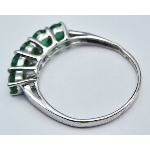 293 - A Stylish 9 Carat White Gold and Five Emerald Set Ring Size N. Set with Five 4mm Quality Round Cut E... 