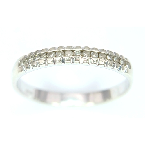 272 - A Stylish 9 Carat White Gold and Channel Set Fifteen Diamond Ring-Size P. The Ring is set with fifte... 