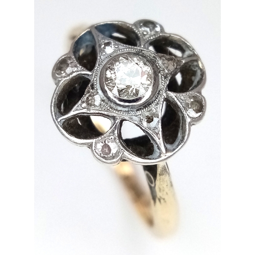 58 - An Antique Edwardian 18K Gold and Platinum Diamond Daisy Cluster Ring. Central diamond surrounded by... 