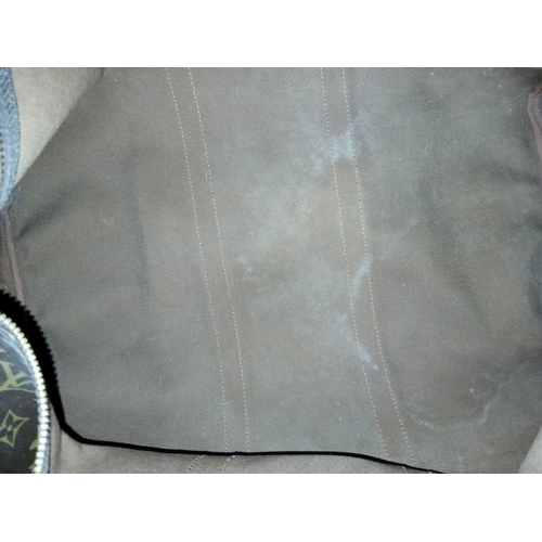 197 - A Brown Louis Vuitton Monogram Keepall 50 Travel Bag. Brown monogram coated canvas exterior with gol... 