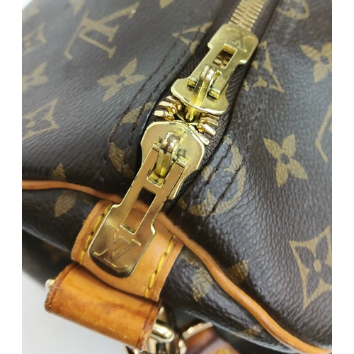 197 - A Brown Louis Vuitton Monogram Keepall 50 Travel Bag. Brown monogram coated canvas exterior with gol... 