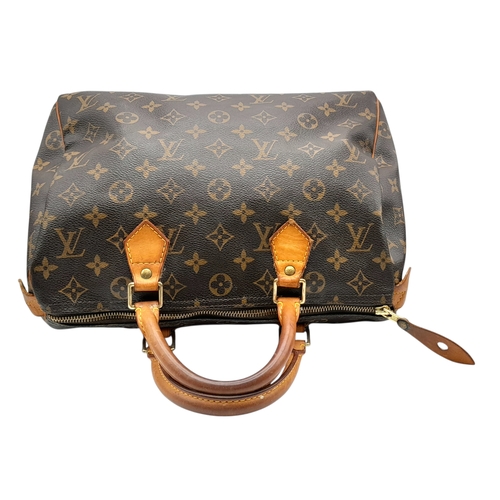 225 - A Brown Louis Vuitton Monogram Speedy 30 Bag. Brown monogram coated canvas exterior with gold-toned ... 