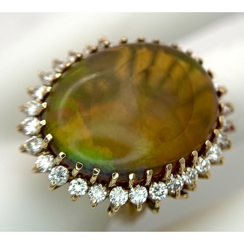 23 - A Stunning Large Opal and Diamond Dress Ring set in 18K Gold. A golden oval cut opal c. 20ct with fa... 