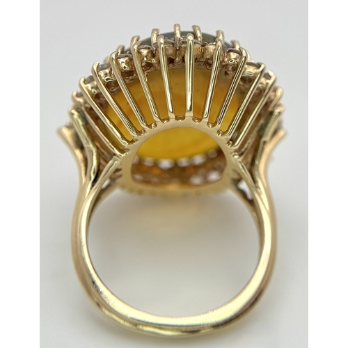 23 - A Stunning Large Opal and Diamond Dress Ring set in 18K Gold. A golden oval cut opal c. 20ct with fa... 