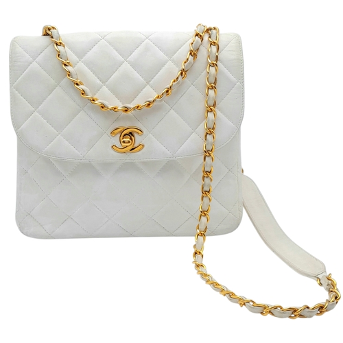 A Chanel Vintage Quilted Shoulder Bag. White quilted leather exterior with gold-toned hardware, chain and leather strap and front flap with CC turn-lock closure. White leather interior with a zipped inner side pocket and open inner side pocket. One open side pocket to the exterior.  Signs of discolouration and creasing to the leather, and pen marks to the interior - please see photos. Approximately 22cm length x 21cm height. Please see photos or request a condition report. Ref: 27388