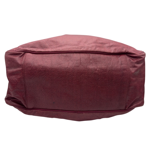 275 - A Yves Saint Laurent Roady Hobo Bag. Burgundy leather exterior with gold-tone hardware and a single ... 