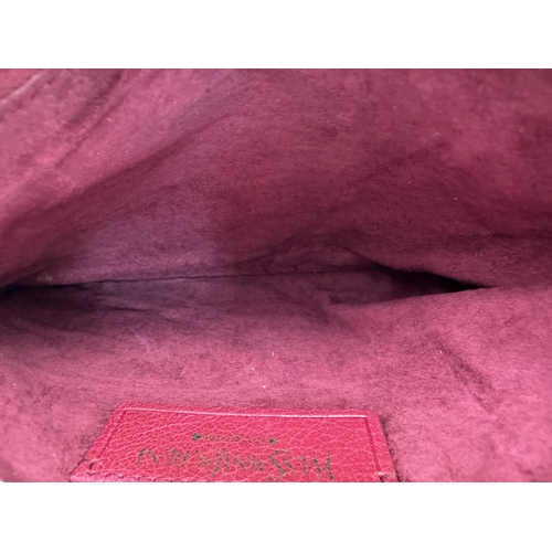 275 - A Yves Saint Laurent Roady Hobo Bag. Burgundy leather exterior with gold-tone hardware and a single ... 