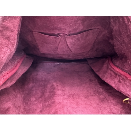 275 - A Yves Saint Laurent Roady Hobo Bag. Burgundy leather exterior with gold-tone hardware and a single ... 