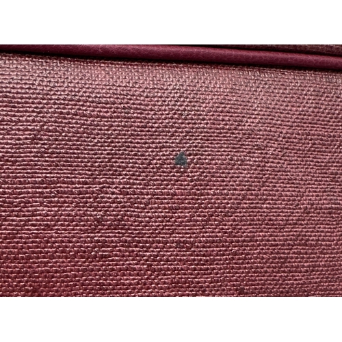 275 - A Yves Saint Laurent Roady Hobo Bag. Burgundy leather exterior with gold-tone hardware and a single ... 