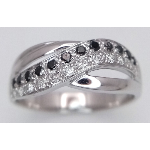 149 - An 18K White Gold Sapphire and Diamond Crossover Ring. Size N. 4g. Ref: 26431.