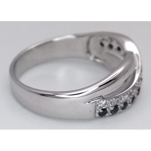 149 - An 18K White Gold Sapphire and Diamond Crossover Ring. Size N. 4g. Ref: 26431.