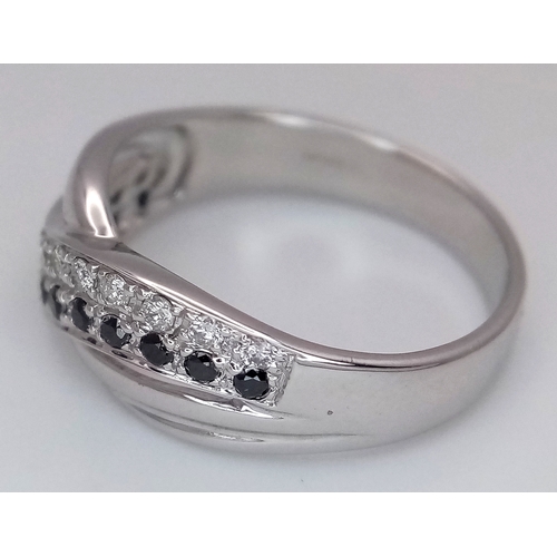 149 - An 18K White Gold Sapphire and Diamond Crossover Ring. Size N. 4g. Ref: 26431.