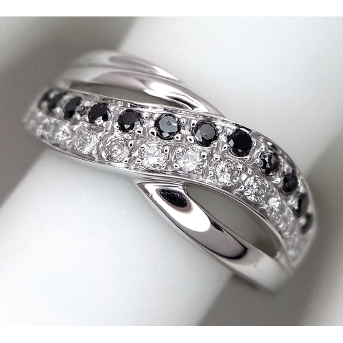 149 - An 18K White Gold Sapphire and Diamond Crossover Ring. Size N. 4g. Ref: 26431.