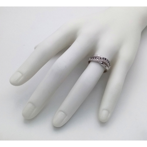 149 - An 18K White Gold Sapphire and Diamond Crossover Ring. Size N. 4g. Ref: 26431.