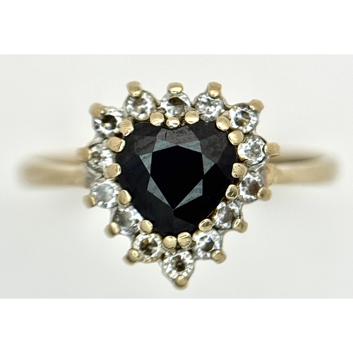 192 - A 9K GOLD RING WITH HEART SHAPED SAPPHIRE SURROUNDED BY DIAMONDS .    1.95gms    size P