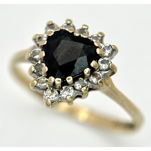 192 - A 9K GOLD RING WITH HEART SHAPED SAPPHIRE SURROUNDED BY DIAMONDS .    1.95gms    size P