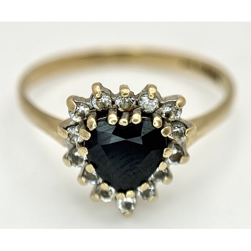 192 - A 9K GOLD RING WITH HEART SHAPED SAPPHIRE SURROUNDED BY DIAMONDS .    1.95gms    size P